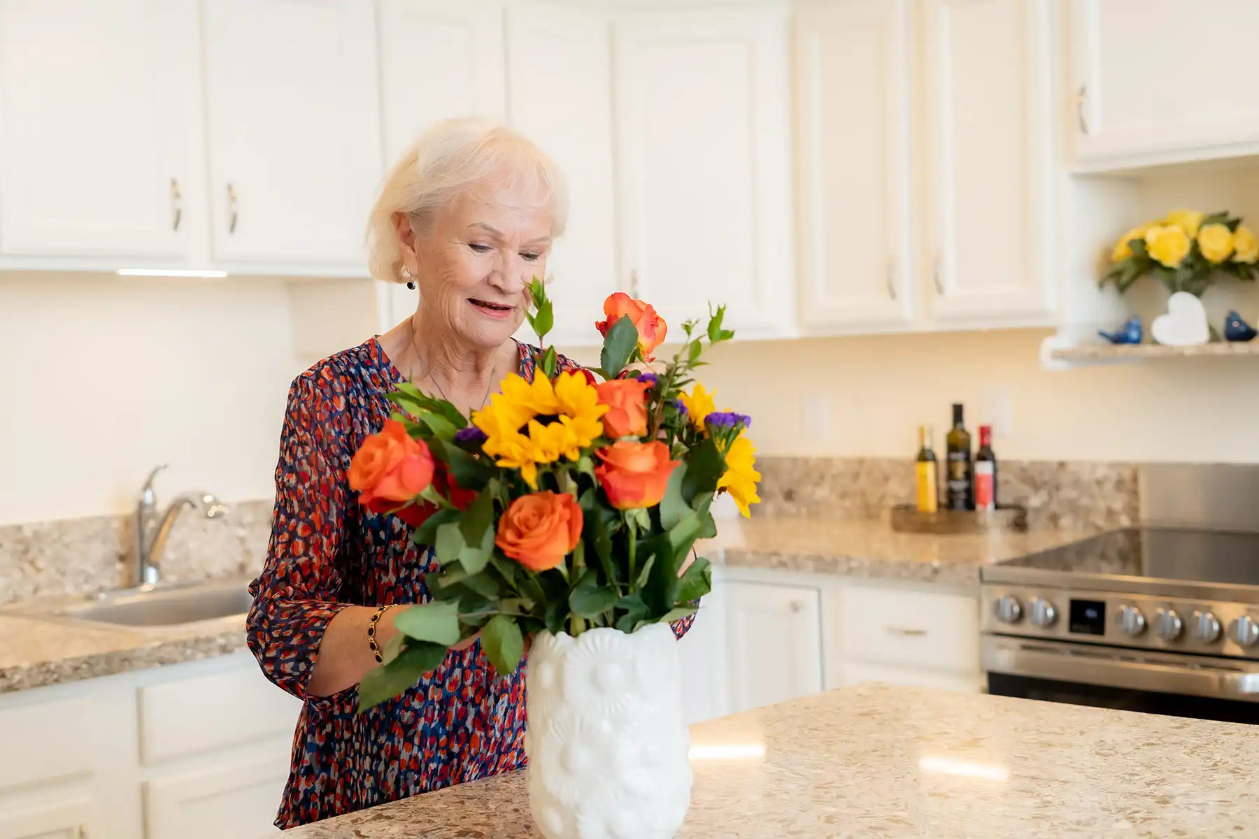 Resident adjusting flowers in vase