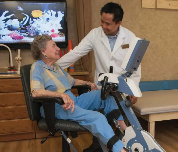 woman on a treadmill talking to a doctor