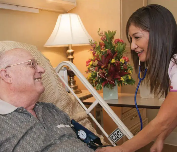 Woman nurse talking to a male patient